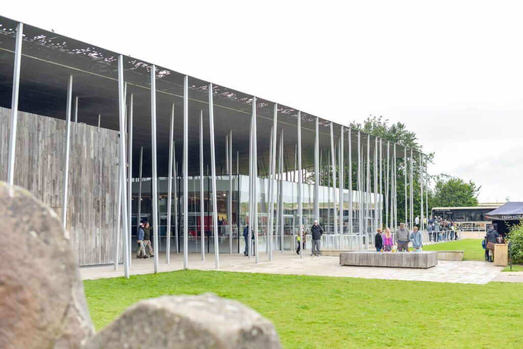 Przeszklony pawilon centrum dla zwiedzających Stonehenge z równym, utwardzonym placem przed wejściem
